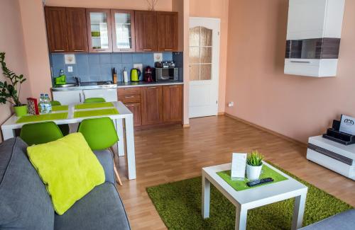 a living room with a couch and a kitchen at Apartament Zwycięstwa in Koszalin