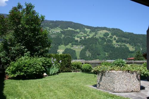 a garden with a view of a mountain at Birkenhof in Zell am Ziller