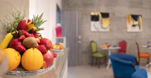 a bowl of fruit on a table in a room at B&B Cantiere dell'anima - Rooms of art in Trapani