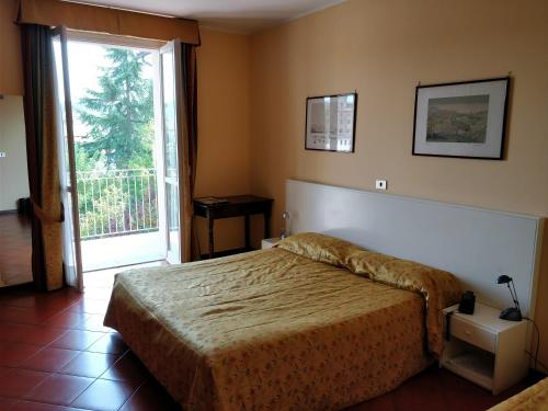 Postel nebo postele na pokoji v ubytování Hotel Barolo Classico