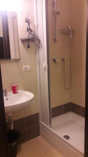 a bathroom with a sink and a shower at Domus Taranto unica sede in Taranto
