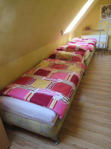 a row of beds lined up in a room at Ferienwohnung Sommer in Friedrichsbrunn