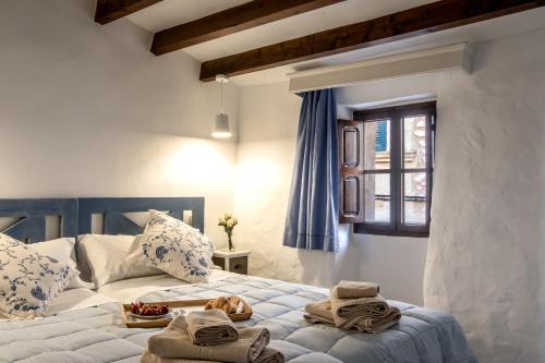 a bedroom with two beds with towels on them at Townhouse on the rocks By homevillas360 in Pollença