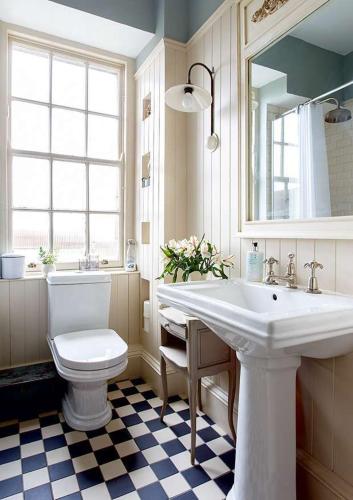 a bathroom with a sink and a toilet and a mirror at Parkway Guesthouse in Dublin