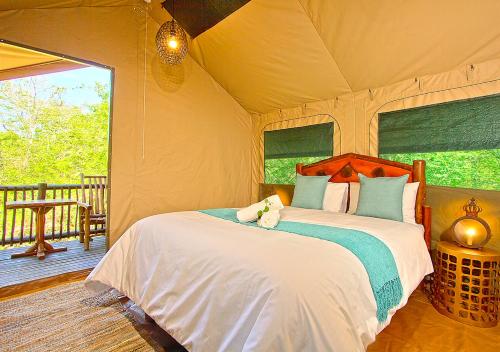 A bed or beds in a room at Kruger Adventure Lodge