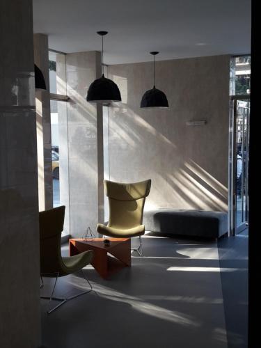 a living room with two chairs and a bed at Miraflores Heart Apartment in Lima