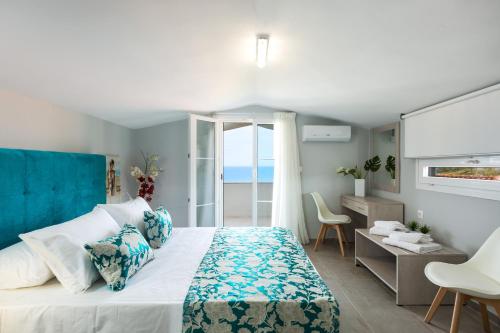 a bedroom with a bed and a view of the ocean at Casa Di Kasapa in Panormos Rethymno