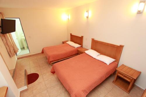 Postel nebo postele na pokoji v ubytování Hotel Santa Rita