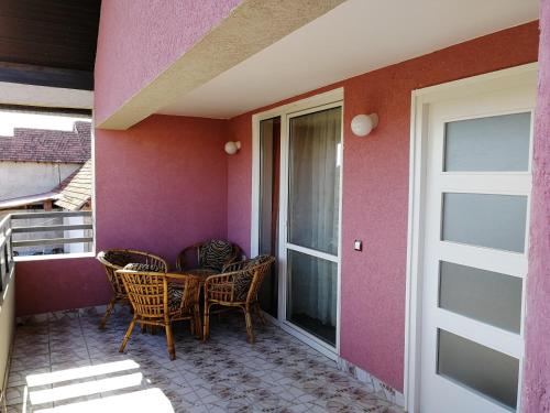 a patio with chairs and a table on a house at Apartments "Predah kod Baraća" in Niš