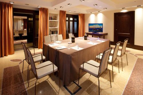 a conference room with a long table and chairs at Grand Hotel Savoia in Genova