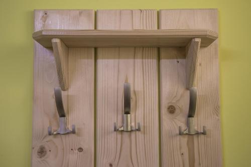 a wooden cabinet with two metal handles on a wall at Arizona Hotel in Uzhhorod