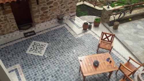 an aerial view of a patio with two chairs and a table at Vernon Villa Stone 1887 in Kastoria