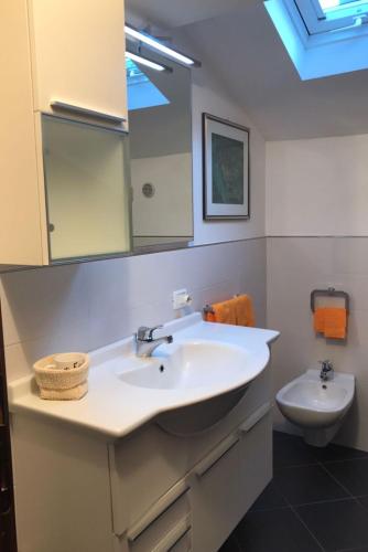 a bathroom with a sink and a toilet at Casa Nika in Riva del Garda