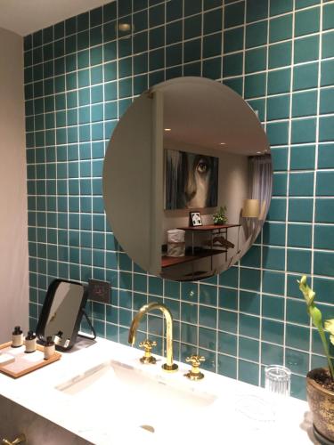 a bathroom with a sink and a mirror at Casa Lelyte in Bogotá