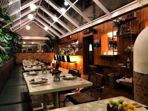 a long table in a restaurant with tables and chairs at Casa Lelyte in Bogotá