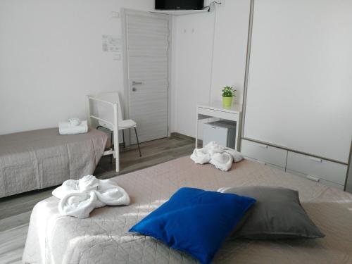 a bedroom with two beds with towels on them at Hotel Marittimo in Rimini