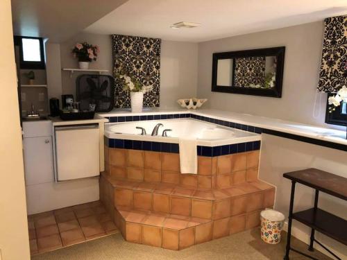 a kitchen with a bath tub with a sink at Barclay House Bed and Breakfast in Vancouver