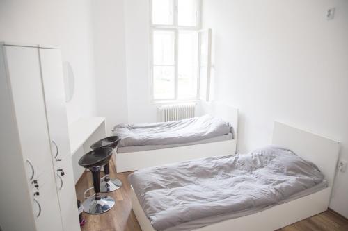 a bedroom with two beds and a window at Lovecroatia Zagreb - 'Pax nest' in Zagreb
