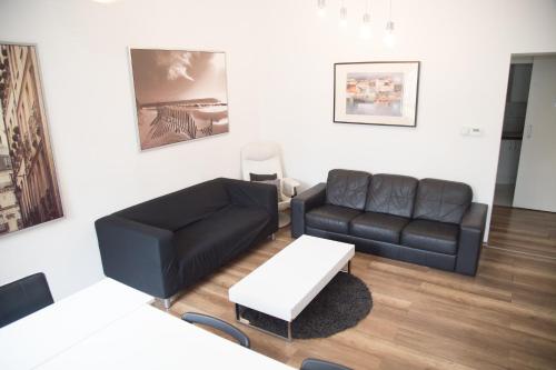 a living room with a couch and a table at Lovecroatia Zagreb - 'Pax nest' in Zagreb