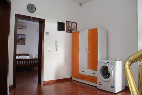 a laundry room with a washer and a washing machine at Hotel Italia in Tirana