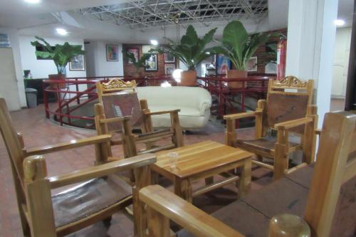 a room with chairs and a table and a couch at Hotel Nuevo Tio in Valledupar