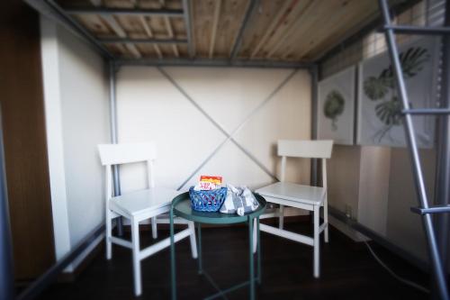 a small room with two chairs and a table at Izu no ie MOANA in Ito