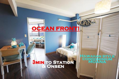 an ocean front room with a room with a bedroom at Izu no ie MOANA in Ito