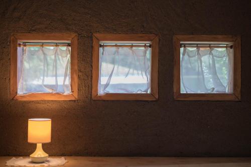 three windows in a room with a lamp at Complejo Cabañas Quilamalen in Villarrica