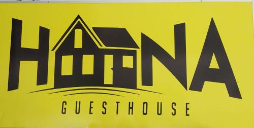 a yellow sign with the name of a guest house at Hana Guesthouse in Kuala Tahan