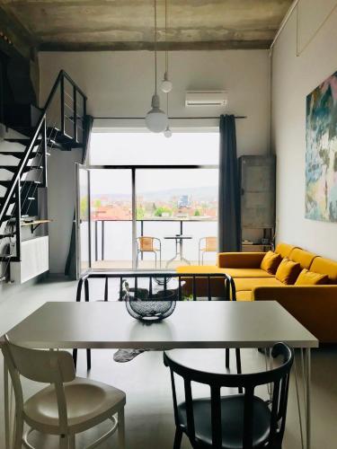a living room with a table and chairs and a couch at Cluj Apartments in Cluj-Napoca