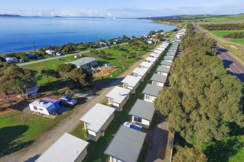 an aerial view of a row of houses next to the water at Port Lincoln Caravan Park in North Shields