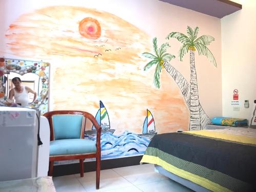 a bedroom with a palm tree mural on the wall at Nan Wan KiKi Guesthouse in Nanwan
