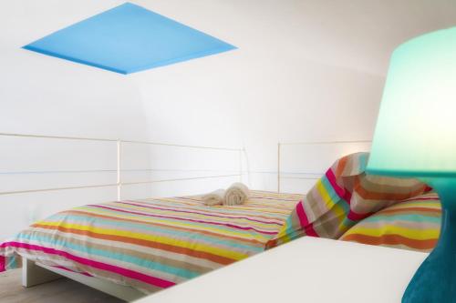 a dog sleeping on a bed in a room at Hello Gaeta Apartment in Gaeta