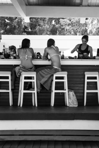 a couple of women sitting at a bar at Villa Di Mare Seaside Suites in Ixia