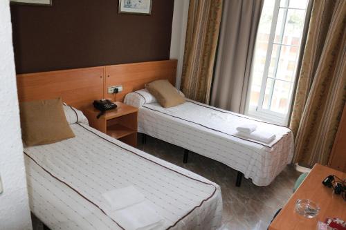 Postel nebo postele na pokoji v ubytování Hotel New Sanz
