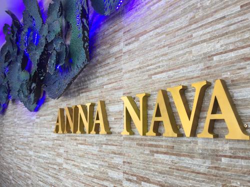 a sign on a brick wall with the amazon logo at Anna-Nava Pakkret Hotel in Nonthaburi