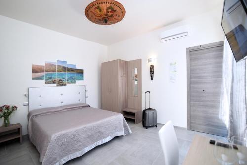 a white bedroom with a bed and a table at The Stunning B&B in Peschici