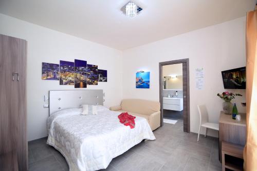 a bedroom with a bed and a chair in it at The Stunning B&B in Peschici