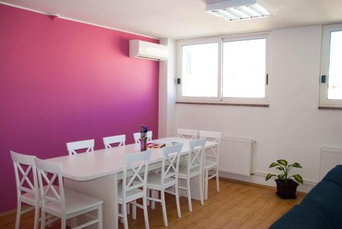 a dining room with a white table and white chairs at Split Summer Budget Rooms in Split