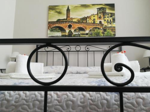 1 dormitorio con 1 cama con una pintura en la pared en A casa di Luca, en Verona