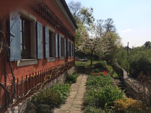 a red building with windows and flowers on the side at Dichterhaus Dresden in Dresden