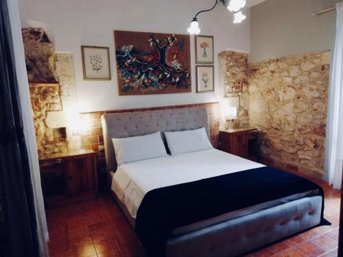 a bedroom with a large bed in a room at B&B Asparano in Ognina