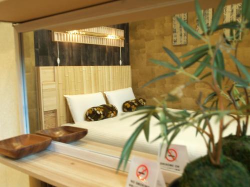 a bedroom with a bed in a display window at Guesthouse Nara Komachi in Nara