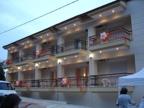 a building with balconies and orange and white balloons at Loxandra Studios in Metamorfosi