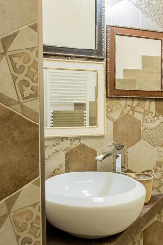 a bathroom with a white sink and a mirror at Residence Hill in San Quirico dʼOrcia