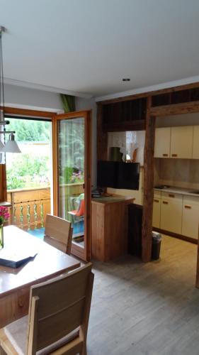 a kitchen and dining room with a table and a television at Haus Patscheider in Nauders