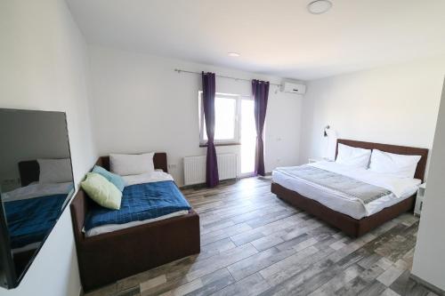 a bedroom with two beds and a window at Guesthouse & restaurant Tekovina in Smederevo