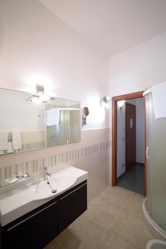 a bathroom with a sink and a mirror at The Stunning B&B in Peschici