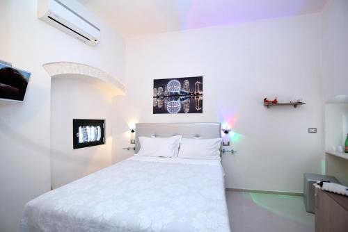 a bedroom with a white bed in a room at The Stunning B&B in Peschici