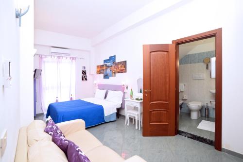 a hotel room with a bed and a bathroom at The Stunning B&B in Peschici